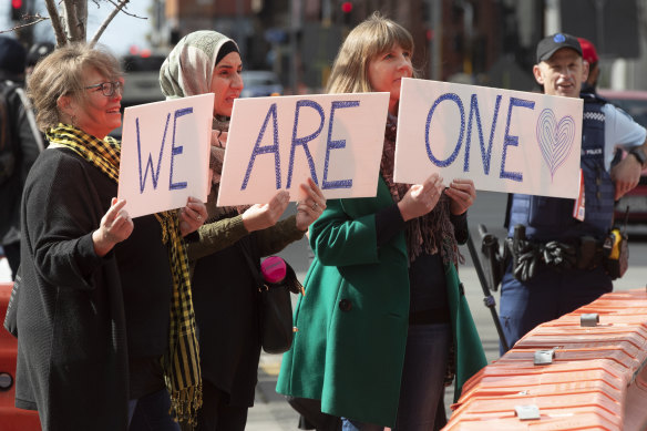 Supporters of the mosque shooting survivors hold signs of support outside the Christchurch High Court after the sentencing of Australian Brenton Harrison Tarrant in Christchurch last year.