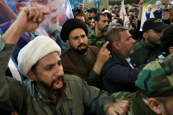 Mourners chant anti-US slogans during a funeral for the officials killed in a US strike.