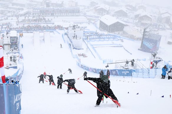 Workers try to clear snow at the aerials site in Livigno.
