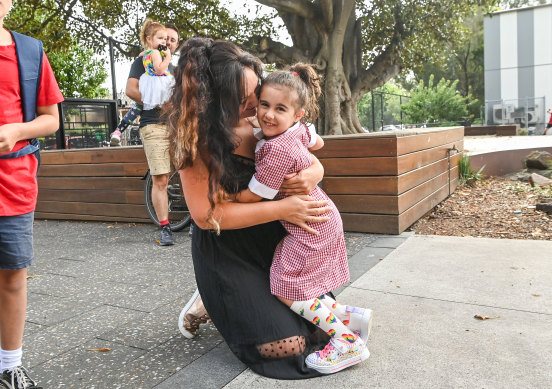 Vanessa Vandonkelaar hugs her daughter Alexis on her first day at school.