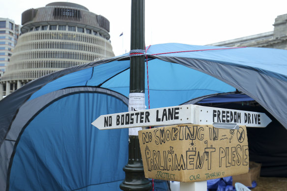 A signpost is erected outside a tent during a protest at Parliament in Wellington, New Zealand, on Wednesday.