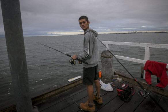 Adrian Forato, 20, fishing off the Kerferd Road Pier in Albert Park on Wednesday.