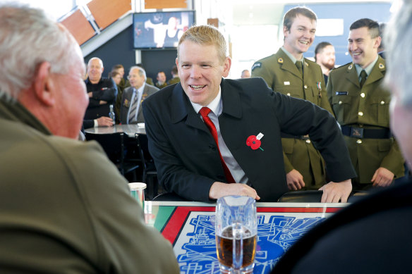New Zealand Prime Minister Chris Hipkins mingles at the Upper Hutt Cosmopolitan Club after attending a dawn service on Anzac Day.