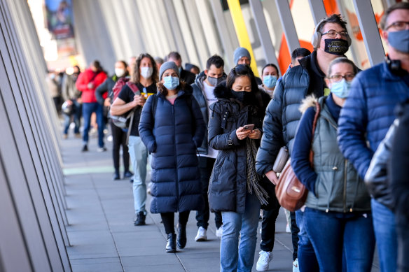 People queue up for COVID-19 vaccinations at the Melbourne Convention and Exhibition Centre. 