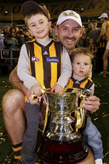 Last hurrah: Veteran Brendan Whitecross with his children after finally scoring a grand final win with Hawthorn.