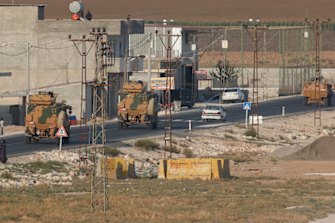A convoy of Turkish forces vehicles drives through the town of Akcakale, Sanliurfa province, in south-eastern Turkey on Wednesday.