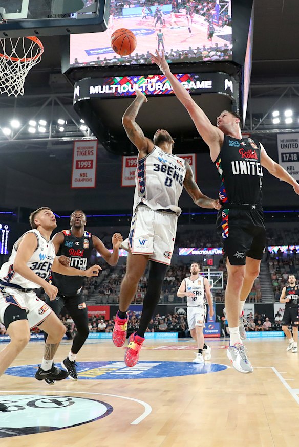 Brad Newley, right, drives to the basket. 