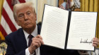 President Donald Trump signs an executive order relating to cryptocurrency in the Oval Office of the White House, Thursday, Jan. 23, 2025, in Washington. (AP Photo/Ben Curtis)