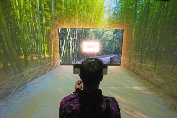 A CES attendee looks on from the immersive room at the LG booth at the tech show.