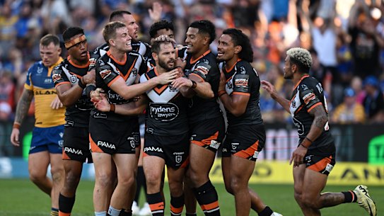 The Wests Tigers celebrate Aidan Sezer’s match-winning field goal against Parramatta.