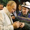 Russian Prime Minister Vladimir Putin examines an uncut chunk of diamond during a visit to Russia’s biggest diamond mine, Mirny, in Siberia in 2009.