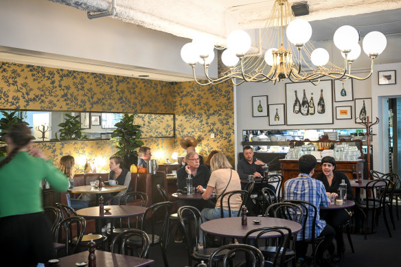 Pope Joan’s interior features a chandelier and golden wallpaper.