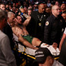 Conor McGregor is carried out of the arena after breaking his leg.