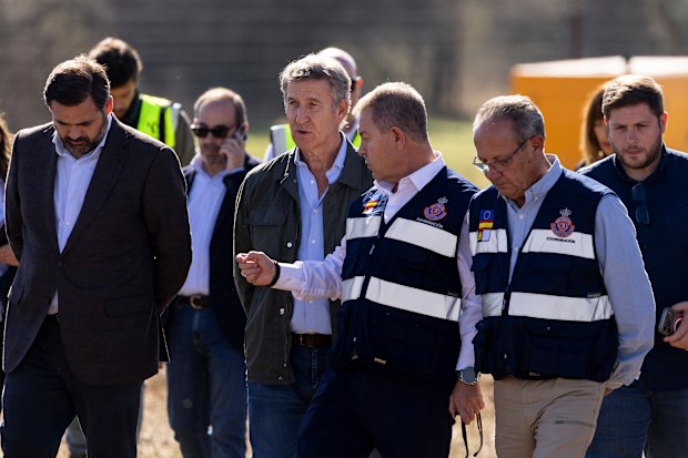 Spain’s People’s Party (Partido Popular) leader Alberto Nunez Feijoo (2L) and Castilla La-Mancha regional president Emiliano Garcia-Page (3R) visits the advanced command post for emergency services near the scene of a train crash 