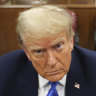 Former president Donald Trump, centre, awaits the start of proceedings at Manhattan criminal court in New York.