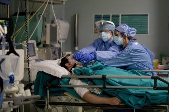 Staff tend to a patient in the emergency COVID-19 ward at the San Carlo Hospital in Milan, Italy