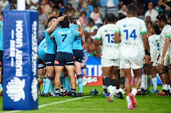 The Waratahs celebrate Dave Porecki’s try.