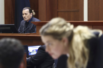 Amber Heard speaks with her legal team as actor Johnny Depp returns to the stand.