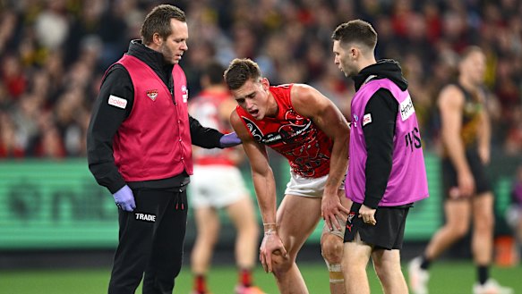 Archer May (centre) was hospitalised on a brutal night on the injury front for Brad Scott’s besieged Bombers.