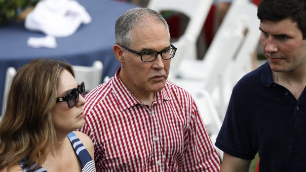 Scott Pruitt, centre, and his wife Marlyn Pruitt, left, attend a picnic for military families in Washington on Wednesday.