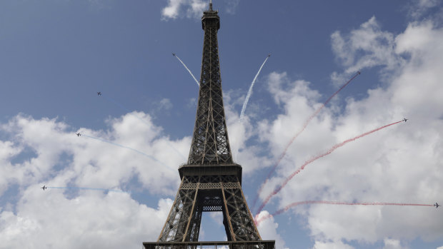 The elite aerial acrobatic team, Patrouille de France, fly by the Eiffel Tower in Paris on Sunday to celebrate the handover of the Olympic flag to the city that will host the 2024 Games.