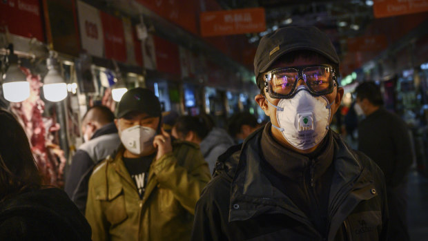 A Chinese shopper wears a mask at a Beijing market.