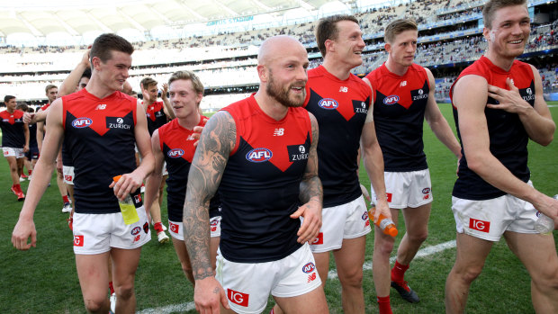 Nathan Jones leads his Demons off the field after their finals-clinching win on Sunday.