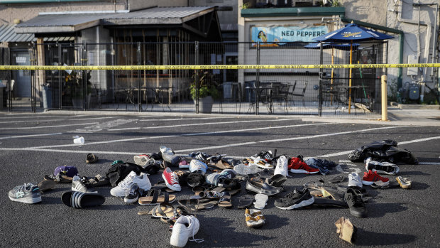 Shoes are piled outside the scene of a mass shooting in Dayton, Ohio in August, in which nine people were killed. 