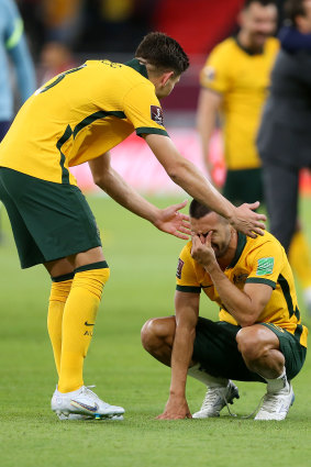 Fran Karacic and Aziz Behich react in the immediate aftermath of their heart-stopping win.