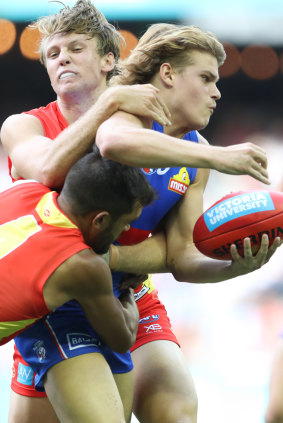 Double-teamed: Bulldog Bailey Smith comes under pressure from a determined Gold Coast defence.