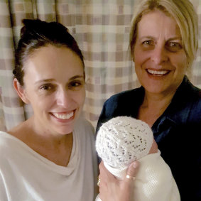 Jacinda Ardern and midwife Libby, no surname given, pose with Ardern's newborn daughter.