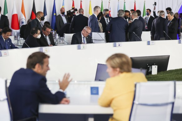 In Rome, Prime Minister Scott Morrison sought French President Emmanuel Macron (foreground) out in a private space. 