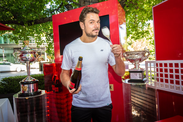 Time to relax: Stan Wawrinka pops a bottle of Piper-Heidsieck champagne.