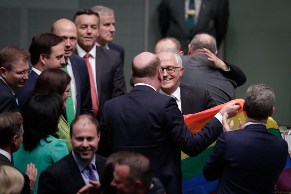 Surrounded by his moderate Liberal allies, then-prime minister Malcolm Turnbull celebrates parliament passing same-sex marriage laws in 2017.