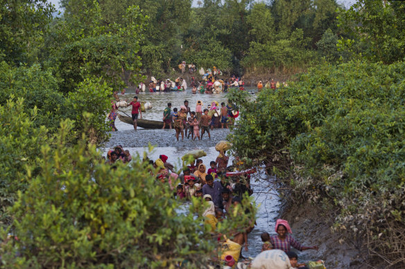 Groups of Rohingya Muslims cross the Naf River at the border between Myanmar and Bangladesh, near Palong Khali, Bangladesh  in 2017.