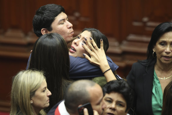 MP Rosselli Amuruz celebrates with colleagues after congress members voted to remove Castillo from office in Lima, Peru.