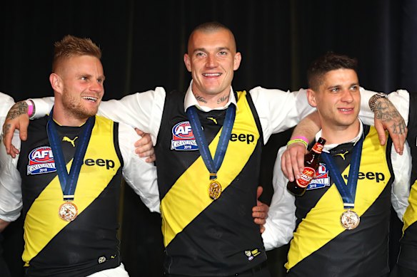 Dion Prestia (right) with Brandon Ellis and Dustin Martin after their 2019 premiership win.