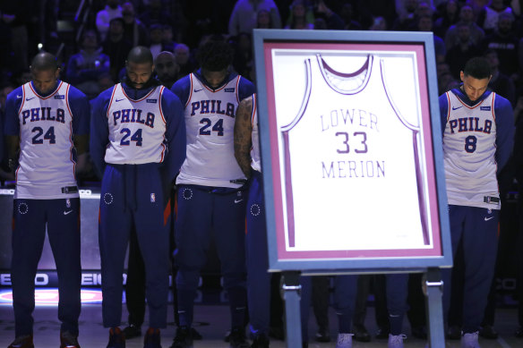 The 76ers stand during a pre-game tribute to Kobe Bryant.