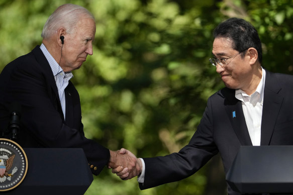 US President Joe Biden shakes hands with Japanese Prime Minister Fumio Kishida at Camp David.