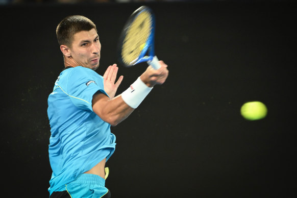 Alexei Popyrin plays a forehand in the round two singles match against Novak Djokovic.