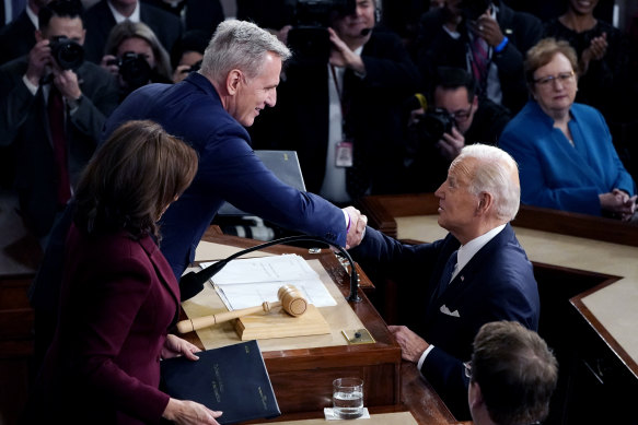 US President Joe Biden arrives and shakes hands with House Speaker Kevin McCarthy during his State of the Union speech in February. Today, the two are at loggerheads over the debt ceiling.