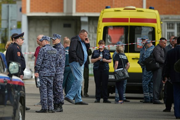 Police and investigators work at the car-bombing scene.