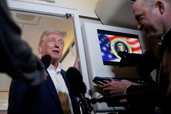 US President Donald Trump talks to reporters on board Air Force One, as he, Elon Musk travel to Palm Beach, Florida.