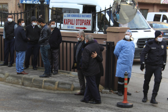 People, police and medics gather outside the Sanko University Hospital in Gaziantep, south-eastern Turkey, after a fire broke out Saturday at an intensive care unit treating COVID-19 patients.