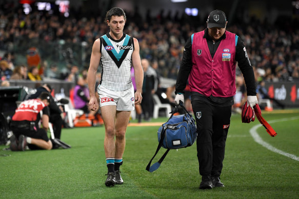 Concussed: Darcy Byrne-Jones is forced from the field on Saturday night.