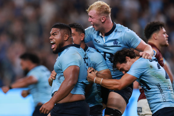 Jamie Adamson (middle) celebrates with teammates after Siosifa Amone’s winning try against the Highlanders