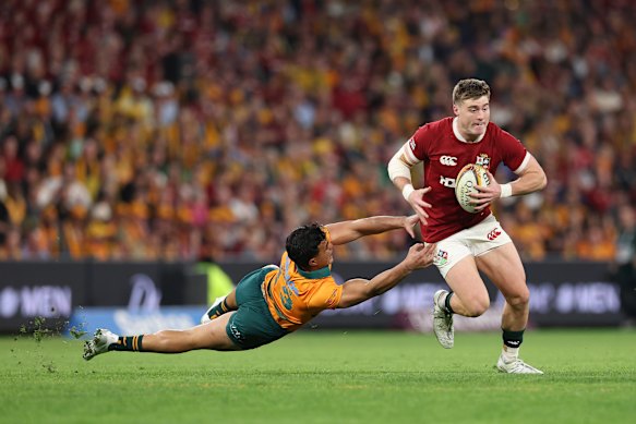 Tommy Freeman of British and Irish Lions gets past Joseph-Aukuso Suaalii 