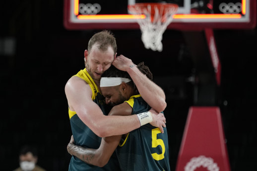 Patty Mills embraces teammate Joe Ingles.