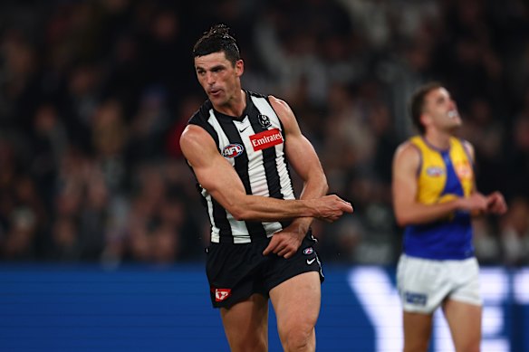 Scott Pendlebury swings an imaginary lightsabre after kicking a goal.