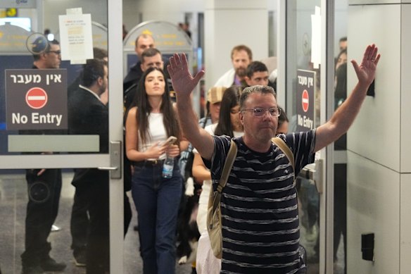 Israeli passenger Haim Lazarovich celebrates a safe return home.